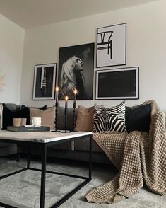 a living room filled with lots of furniture and pictures on the wall above it's coffee table