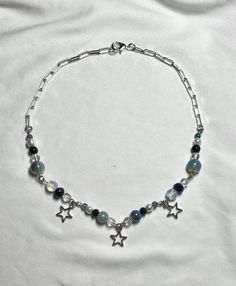 handmade by me :) made with various glass beads, and a lobster claw clasp the necklace measures 17 inches total but can be adjusted for a smaller fit treat gently as costume jewelry let me know if you have any questions Blue Star-shaped Beaded Necklace, Adjustable Blue Beaded Star Necklaces, Blue Adjustable Star-shaped Beaded Necklaces, Adjustable Blue Star-shaped Beaded Necklace, Handmade Blue Star Beaded Necklaces, Handmade Blue Beaded Star Necklaces, Handmade Blue Star-shaped Beaded Necklaces, Blue Star-shaped Jewelry With Colorful Beads, Celestial Blue Beaded Necklaces