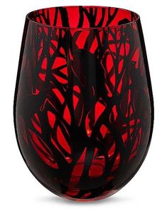 a red and black glass vase sitting on top of a table