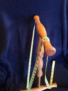 a wooden mannequin with measuring tape around it