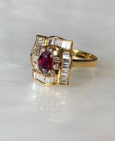 "Ruby Diamond Ring, Ruby Ring, Vintage Ruby Ring For Women, Oval Ruby, Vintage Ruby Engagement Ring, Ruby Right Hand Ring, Vintage Jewelry Say \" I love you\" with this delicate and feminine traditional oval ruby ring with meticulous detailing. This 18k yellow gold ring features a true red oval ruby weighing 0.61 carats surrounded by a shining halo of round diamonds which is also surrounded with sparkling baguette diamonds in a beautiful lattice pattern. the total diamond weight is: 0.69 carats. Oval Ruby Ring, Vintage Ruby Ring, Ruby Engagement Ring Vintage, Engagement Ring Ruby, Antique Emerald Ring, Ruby Ring Vintage, Vintage Sapphire Ring, Ruby Diamond Ring, Emerald Ring Vintage