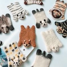 there are many different animal finger puppets on the table, including cats and pandas