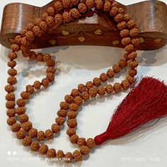 This is a divine Rudraksha five Mukhi beads mala with a beautiful red tassel and 15 mm Rudraksha guru bead The number 108 is significant for so many reasons. Some believe there are 108 stages on the journey of human soul, while others associate the possibility of enlightenment with taking only 108 breath a day while in deep meditation. Spiritually Rudraksha mala have been used for meditation since centuries. One legend say that once when Lord Shiva opened his eyes after a long period of yogic meditation, he felt sense of extreme fulfilment. It made him shed a tear. This single tear from Shiva eyes grew into Rudraksha beads are believed to promote inner peace, knowledge, power and enlightenment. These beads are small and considered rare falling from trees high up in Himalayas Rudraksha mala Spiritual Gemstone Beads Mala For Puja, Spiritual Gemstone Mala For Puja, Spiritual Mala With Gemstone Beads For Festivals, Handmade Spiritual Mala For Diwali, Spiritual Handmade Mala For Diwali, Spiritual Mala For Diwali Rituals, Gemstone Beads Mala For Puja And Festivals, Festival Gemstone Beads Mala For Meditation, Handmade Mala For Meditation And Diwali