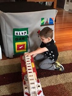 a young boy playing with a toy train set