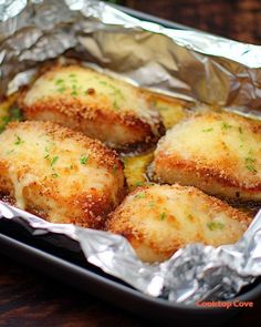 some food that is sitting on top of tin foil in a pan and ready to be eaten