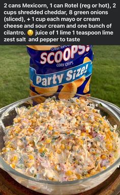 a large bowl filled with food sitting on top of a table next to a can of soup