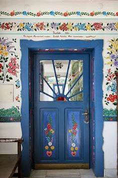 a blue door with flowers painted on it and the words save are in red, white, and blue