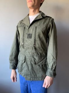 French Work Jacket / Bleu de travail / French Workwear / French Chore Coat / French Army Combat Jacket F2 / Size S This vintage French military jacket in good used condition! - made in France - ERA - 1970's - color - gray / green - 4 outside pockets  - 2 buttons on the cuff - 6 buttons at front - material - cotton - label size - 88C (fit S) (watch measurements) FLAT Measurements: Shoulders: 42cm Chest (underarm to underarm): 47cm Sleeve: 58cm Length(back): 75cm Model height and weight reference (cm/kg): 176/68 Pay your attention to that  most antique items have been used and may have minor flaws. Please , read the description carefully and check the measurements! SHIPPING: UkrPosta Airmail Shipping: - Europe: 23$ - 14-31 days (No shipping to Germany!) - United Kingdom: 23$ - 14-31 days  - Green Utility Jacket With Side Pockets For Work, Military Style Long Sleeve Cotton Sport Coat, Military Style Cotton Sport Coat With Long Sleeves, Khaki Workwear Parka With Side Pockets, Long Sleeve Utility Windbreaker With Pockets, Utility Sport Coat With Patch Pockets And Long Sleeves, Utility Windbreaker With Pockets, Utility Long Sleeve Sport Coat With Patch Pockets, Utility Workwear Windbreaker With Side Pockets