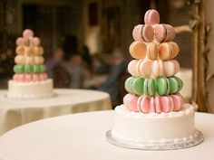 there are many macaroons stacked on top of each other at this wedding cake