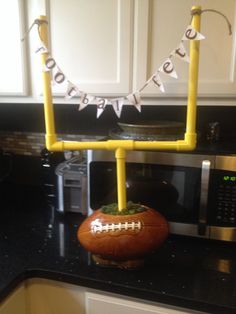 an orange football sitting on top of a kitchen counter next to a microwave and oven