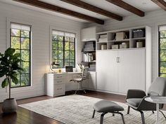 a living room filled with furniture and lots of windows next to a white desk on top of a hard wood floor