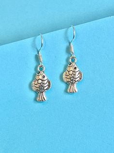 Fish mini dangle earrings for those fish lovers out there... beautiful and dainty.  The hook is made of plated sterling silver to protect your ears and the fish is made from Tibetan silver.  They come well presented and wonderful for a present for a friend, family or your loved one. I offer free UK postage and will despatch same day as purchase.  Thank you for taking the time to look at my earrings and please visit my shop for more original designs. Bespokedanglers.  For Fun, Funky, Quirky and o Silver Sterling Fish-shaped Earrings, Silver Fish-shaped Sterling Silver Earrings, Silver Fish-shaped Earrings With Ear Wire, Silver Fish-shaped Earrings With Fish Hooks, Nickel-free Silver Fish-shaped Earrings, Fish Earrings, Present For Her, Le Crochet, Presents For Her