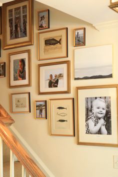 a staircase with many framed pictures on the wall