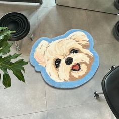 a rug with a dog's face on the floor next to a chair and potted plant