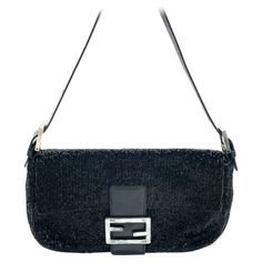 Fendi Baguette Vintage Black Glitter Beads Shoulder Bag Discover the Fendi Baguette Vintage Black Glitter Beads - a masterfully crafted, iconic design enhanced with shimmering beads. This exquisite piece of art is versatile and can elevate any outfit, making it a timeless addition to your wardrobe. CONDITION: VERY GOOD This vintage preloved Fendi baguette is in very good condition with minimal signs of wear. Most beads are in tact, and there are a few scratches on the leather of the flap. DETAIL Fendi Baguette Vintage, Fendi Vintage, Structured Shoulder, Fendi Baguette, Outfit Making, Iconic Design, Black Hardware, Black Glitter, Fashion Handbags