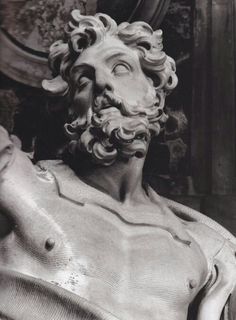 a statue of a man with curly hair and beard