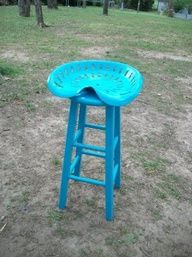 a blue stool sitting in the middle of a field