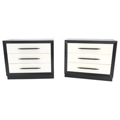 two black and white dressers sitting side by side