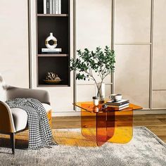 a living room filled with furniture and a book shelf on top of a wooden floor