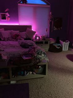 a bed room with a neatly made bed and purple lighting