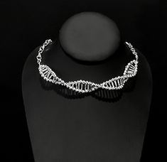 This beautiful statement necklace is an artistic representation of a DNA Double Helix Strand.   The necklace can be worn up to approximately 21 inches but, because of the shape of the links can be clasped at just about any length.  DNA pendant accounts for 6 inches of it. It is a stunning statement piece!  The DNA pendant is made with beads and jewelers wire.  The chain is zinc alloy costume jewelry.   Thank you for shopping with me! Follow me on Instagram for coupon codes, new inventory, and sales! @biolojewelry   I ship USPS so, please allow 3-10 business days for your item to arrive after you receive your shipping notification. (USA) Please allow 10-40 business days for international delivery Lsd Molecule, Dna Necklace, Dna Methylation, Dna Strand, Double Helix, Food Themes, Helix, Chain Styles, Coupon Codes