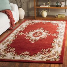 a living room with a red rug on the floor