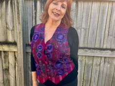 This 1990's women's vintage vest  is such a delightful piece! A v-neck button down style with a black satin back and a plum and pink striped front. The front is covered with stunning floral embroidery in deep purples, blue, brown and black. It features lovely fabric covered buttons and is fully lined with adjusting straps on back. Excellent quality. Made in Guatemala. 51% cotton, 16% rayon, 33% acetate Size Medium. Measurements: Chest: 102 cm / 40 inches Length: 56 cm / 22 inches BUYING VINTAGE: While all care is taken to state any obvious faults, please note that when you buy a vintage or preloved item, they may show small signs of ageing, wear and/or repair. Visit my new website   https://phoenixmenswear.com.au/ Lots of fun stuff for guys and girls...!! Please note that if you are orderi Fitted Vintage V-neck Vest, Retro V-neck Fitted Vest, Fitted Pink Vest For Fall, Casual Fitted Purple Vest, Fitted Casual Purple Vest, Purple Sleeveless Vest For Fall, Retro Fitted V-neck Vest, Fitted V-neck Vintage Vest, Longline Denim Jacket