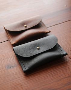 "The Clark card/pocket wallet is made out of super sturdy 6 oz Kodiak leather that will weather amazingly. Enough room to hold a few credit cards and some cash, small emough to fit in your pocket comfortably. Silver button stud closure. 4\"w x 3\"h Available in black and brown, dark and light cowhide. Light will be mostly brown + white, dark will be mostly black and black + white. If there is a certain type of cowhide you want specifically, please add a note with your order and we will try to ac Pocket Card, Silver Button, Handmade Leather Wallet, Pocket Cards, Pocket Wallet, Minimalist Wallet, Money Clip Wallet, Small Wallet, Bag Handle