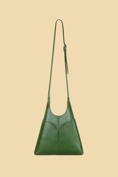 One of our best-selling styles. Made from semi-patent green cactus leather, the Pilar Crossbody features a magnetic closure, a blind embossed logo, an interior slip pocket and four outer pockets. Product Info: Height: 24.5cm (without strap)Length: 24cmStrap Maximum Drop: 45cm (adjustable)Width: 4.5cm All Santos products are handmade to order in the US. In collaboration with Desserto, our plant-based leather is crafted from cactus fibers and made in Mexico. Our lining is made from 100% Organic Co Modern Green Textured Leather Shoulder Bag, Modern Green Shoulder Bag With Leather Lining, Classic Green Shoulder Bag With Magnetic Closure, Modern Green Bag With Leather Lining, Green Leather Bag With Snap Closure, Classic Green Textured Leather Shoulder Bag, Green Leather Shoulder Bag With Snap Closure, Green Leather Shoulder Bag With Magnetic Closure, Green Leather Bag With Magnetic Closure