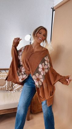 Embrace your fun and flirty side in the Bloom Into You Floral Boho Top! This oversized top features a playful daisy patch on the front and back, adding a pop of color to your fall look. The oversized fit adds a comfortable and carefree vibe to your style. Oversized Top Mineral Washed Daisy Patches Fully Embroidered Pockets 😍 V Neckline Dropped Shoulders Side Slits Asymmetrical Hemline Exposed Seams Frayed Details Measurements/Sizing: (Approximate. Measured lying flat.) ***Oversized fit. Back gr Oversized Bohemian Patchwork Tops, Oversized Hippie Tops For Fall, Fall Bohemian Tops For Loungewear, Bohemian Oversized Top For Day Out, Oversized Bohemian Top For Day Out, Hippie Brown Long Sleeve Tops, Brown Patchwork Top For Fall, Fall Brown Patchwork Tops, Oversized Long Sleeve Hippie Top