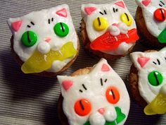 four decorated cupcakes sitting on top of a table