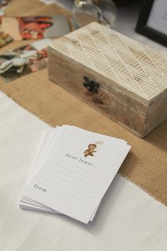 a wooden box sitting on top of a table next to some papers and other items