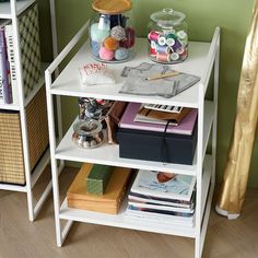 a shelf filled with books and craft supplies