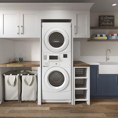 a washer and dryer in a kitchen next to cabinets with baskets on the floor