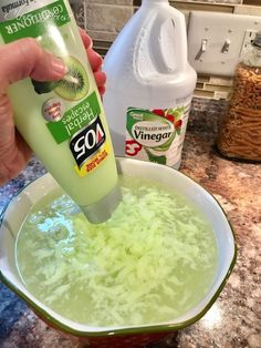 someone is pouring vinegar into a bowl of food