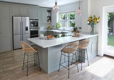 a kitchen with an island and three stools