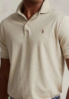 An American style standard since 1972, the Polo shirt has been imitated but never matched. Over the decades, Ralph Lauren has reimagined his signature style in a wide array of colors and fits, yet all retain the quality and attention to detail of the iconic original. This roomy version is made from luxe cotton interlock with an ultrasoft finish. Ralph Lauren Polo Shirts Men Outfit, Classic Beige Cotton Tops, Ralph Lauren Cotton Polo Collar Top, Ralph Lauren Cotton Polo Top, Classic Beige Short Sleeve Shirt, Classic Fitted Crew Neck Shirt, Ralph Lauren Fitted Polo Collar T-shirt, Ralph Lauren Fitted Polo T-shirt, Ralph Lauren Fitted Casual Polo Shirt