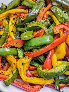 a white plate topped with green and red peppers