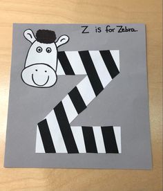 a paper cut out of a zebra with the letter z on it's face