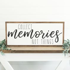 a wooden sign that says collect memories not things on the side of a white table