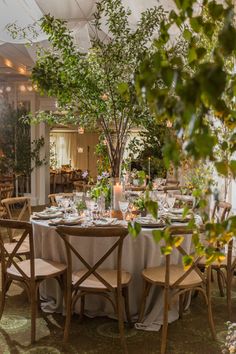 a dining room with tables and chairs set up for a formal dinner in the evening