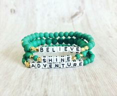 "Word Affirmation bracelet Sets accented with Letter Beads Shine Adventure Believe Materials: multi size green glass beads, acrylic letter beads 3 Piece Set Stackable Bracelet sets Stretch Bracelet approximately 6.75\" length Made of very resilient clear cording Please visit my shop for more listings at www.fernhomeandfashion.etsy.com" Adjustable Green Bracelets With Letter Beads, Green Name Bracelet With Letter Beads, Green Letter Beads For Jewelry Making, Green Personalized Bracelets With Round Beads, Personalized Green Bracelets With Round Beads, Green Beaded Name Bracelet For Friendship, Personalized Green Beaded Bracelets For Friendship, Green Beaded Bracelets With Letter And Round Beads, Green Letter Beads Name Bracelet For Friendship