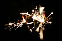 a close up of a sparkler in the dark