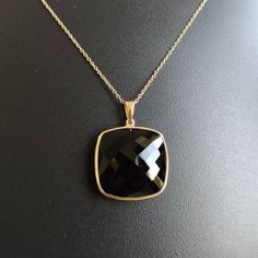 ITEM DESCRIPTION: >>The pendant is made from Solid 14K Yellow Gold. Gemstone used is absolutely natural and ethically sourced. >>Natural Black Onyx of cushion shape in bezel setting is studded on it with utmost precision. >>This is a minimalist design and is absolutely hassle-free and everyday jewelry. Gem: Black Onyx Gem size: 20x20 mm Gem weight: 19.71 carats Gold purity: 14K (58.33% approx.) Gold weight: 0.74 grams Gross weight: 4.68 grams The Gold purity is guaranteed and it comes with authe Black Faceted Jewelry As A Gift, Black Faceted Jewelry For Gift, Black Enamel Necklace For Anniversary, Black Pendant Jewelry For Anniversary, Classic Onyx Jewelry For Party, Formal Black Jewelry With 17 Jewels, Black 14k Gold Pendant Jewelry, Elegant Black Hallmarked Jewelry, Black Onyx Jewelry For Formal Occasions