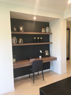 a black and white living room with shelves on the wall