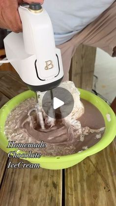 a person pouring chocolate into a green bowl