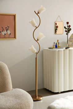 a modern floor lamp in the corner of a room with a white rug on the floor