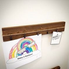 there is a sign on the wall that says make a rainbow and a drawing of a rainbow