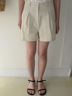 Cut from rayon and linen blend fabric, these shorts have simple yet sophisticated design and are accentuated with pleated tucks through front.  - Natural, relaxed silhouette- A-line design in short length- Classic hook and eye closure- Casual belt loop details- Lined for added flexibility Summer Pleated Waist Bottoms For Day Out, Casual Workwear Bottoms With Box Pleat, Cotton Bottoms With Pleated Waist In Short Length, Cotton Bottoms With Pleated Waist And Short Length, Beige Pleated Waist Bottoms For Summer, Pleated Short Length Bottoms For Day Out, Pleated Short Bottoms For Day Out, Summer Beige Bottoms With Pleated Waist, Linen Shorts With Short Inseam For Day Out