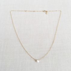 "This is a single pearl necklace made of genuine high quality fresh water pearl. There are gold filled ,sterling silver and 14kt gold chain you can choose from. Each necklace has 2\" extender. There are 2 sizes that you can choose from 14\"-16\" and 16\"- 18\" in gold filled or sterling silver. 14k gold necklace will be in single size without extender. This fresh water pearl necklace is light weight and elegant. This tiny pearl necklace is around 5mm. This pearl necklace is great for layering wi Minimalist White Pearl Necklace With Charm, Simple Pearl Drop Necklace For Gifts, Minimalist Everyday Pearl Necklace With Round Pendant, Minimalist Pearl White Round Pendant Necklace, Simple Pearl Chain Necklace, Delicate Round Pearl Necklace For Everyday, Delicate Everyday Pearl Necklace, Simple White Pearl Drop Necklace, Simple Pearl Necklace With Clavicle Chain As Gift